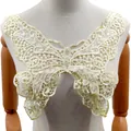 Macro view of cream water-soluble lace butterfly applique with intricate embroidery - Beige