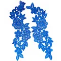 Macro view of blue water-soluble floral embroidery lace patches for DIY clothing decor - Blue