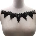Macro view of black water-soluble lace embroidery patch with intricate hollow-out floral pattern - Black