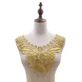 Detail of a gold water-soluble lace collar with floral embroidery on a mannequin. - Gold Lurex