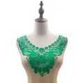 Detailed macro view of green water-soluble lace collar with 3D floral embroidery on mannequin - Green