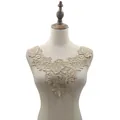 Detailed view of elegant rose embroidered water-soluble lace collar on a dress form - Khaki