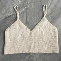 Detailed view of the intricate floral crochet patterns on this beige knit camisole - One Size / Tops / Milky White