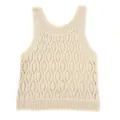 Detailed macro view of apricot knit sleeveless top featuring intricate hollow geometric patterns. - One Size / Tops / Apricot