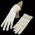 Detailed macro view of white satin bridal gloves featuring elegant beaded pearl cuffs - One Size / Off White