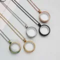 Close-up of circular stainless steel locket pendants in various metal finishes. - Pendant with Necklace / Gold / 20mm