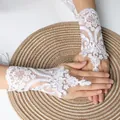 Elegant short white lace bridal wedding gloves with finger hook and delicate floral pattern - One Size / White