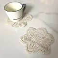 Close-up of a beige crocheted cotton lace coaster in a star shape on marble surface - Diameter 13.5cm (Hexagram Shape) / 93# (Off-White)