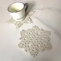 Close-up of handmade beige crochet snowflake coasters on a white marble tabletop. - Style 84# Snowflake / Diameter 15cm / Apricot
