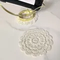 Close-up detail of a vintage white crochet lace coaster with hollow flower embroidery - 90# Style
