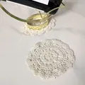 Close-up of vintage off-white hollow crochet lace coaster on marble table - Style 91#