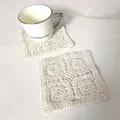 Detailed view of two cream square crocheted cotton coasters on marble background - Round Simple Hollow Coaster (11)