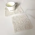 Detail view of retro beige lace crochet coasters on white marble - Round Dense Lace Coaster (15)