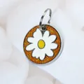 Round white daisy pet ID tag featuring a sparkling orange glitter background for dogs and cats - 14mm Ring / Orange