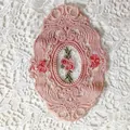 Detailed view of pink oval lace coaster with delicate floral rose embroidery. - 21*14.5cm / Dusty Pink