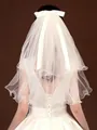 Back view detail of a short white bridal veil featuring a layered mesh and satin bow - White without Pearls