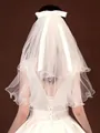 Elegant short white tiered bridal veil featuring a large silk bow and curly wavy edges - White without Pearls