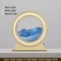 Lámpara de mesa LED circular dorada moderna con exhibición dinámica de arte de arena azul - Batería Seca/Enchufe / 10" / Marco Dorado Arena Azul
