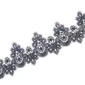 Detailed macro view of navy blue water-soluble lace trim with intricate 3D hollow embroidery - Black