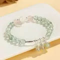 Elegant handmade rose quartz and prehnite beaded bracelet with silver charm accents. - Prehnite Blue Moonstone & Rose Quartz Style