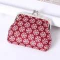 Vintage red coin purse featuring a geometric pattern and a classic metal kiss-lock clasp - Geometric Circular Pattern / Red