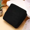 Portable black corduroy square pouch for sanitary napkins featuring a smooth zipper closure. - Black