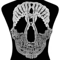 Close-up of white water-soluble lace skull embroidery patch with hollow DIY detail. - White