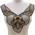 Detail of black and gold embroidered lace collar applique on a white mannequin torso. - Black & Gold