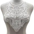 Detailed macro view of white wolf head lace applique featuring intricate 3D embroidery - Wolf Head / White
