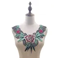 Detailed view of colorful water-soluble embroidered floral collar on mannequin - Green