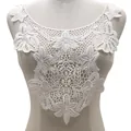 Detailed view of white water-soluble lace collar applique on a mannequin torso - White