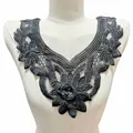 Black floral water-soluble lace collar applique with intricate embroidery displayed on mannequin - Black