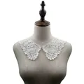 Detailed view of white water-soluble lace collar with 3D hollow embroidery - White