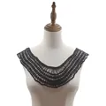 Detail shot of a vintage black hollow lace crochet collar applique on white mannequin - Black