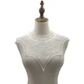 Close-up of white water-soluble lace embroidery collar on a mannequin - White
