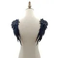 Detailed view of heavy-duty black angel wing lace embroidery patches on mannequin. - One Pair / Black