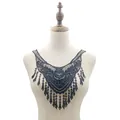 Detailed view of a black water-soluble lace collar applique with tassels on a mannequin - Black