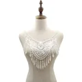 Detailed macro view of white water-soluble lace collar with elegant hollow embroidery and fringe - White