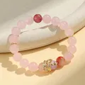 Elegant pink rose quartz beaded bracelet featuring a gold snake charm and purple crystal - Rose Quartz & Strawberry Quartz