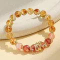 Elegant beaded bracelet featuring yellow citrine, red phantom quartz and a gold snake charm - Citrine & Hematoid Quartz