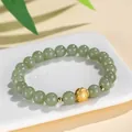 Elegant ethnic style green Hetian jade bead bracelet featuring a golden coin charm design - Copper Coin Style / 8mm / 999 Silver 8mm Hetian Jade Copper Coin Bracelet