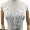 Detailed macro view of white floral water-soluble lace embroidery fake collar patch. - White