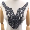 Detailed view of black water-soluble lace collar with intricate hollow embroidery pattern - Black