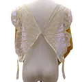 Detail view of cream butterfly lace embroidery on a mannequin back for garments - Beige