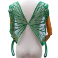 Detailed macro view of large green butterfly wing lace embroidery patch on mannequin back - Green