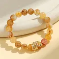 Natural yellow crystal beaded bracelet featuring a stylish gold snake charm for women - Yellow Hematoid Quartz