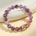 Elegant purple phantom quartz beaded bracelet featuring a detailed golden snake charm for luck - Purple Phantom Quartz