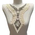 Detailed view of intricate embroidered lace collar applique on a mannequin torso - Black