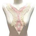 Close-up detail of pink and cream embroidered lace fake collar with floral hollow design - Pink