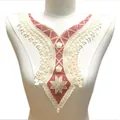 Detailed view of an elegant red and white embroidered lace collar for clothing accessories. - Burgundy